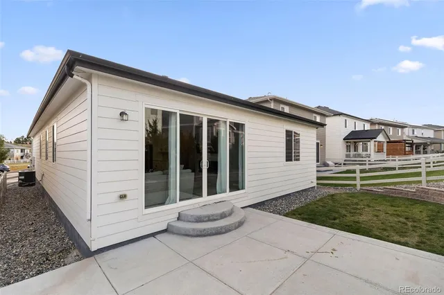 a view of a white house with a yard