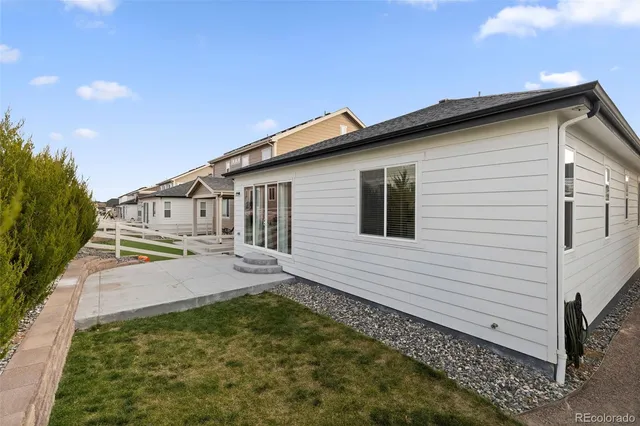 a white house that has tree in front of it