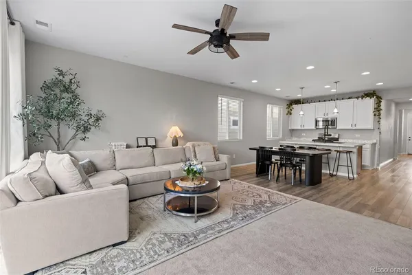 a living room with furniture and kitchen view