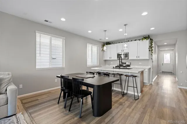 a kitchen with a table and chairs in it