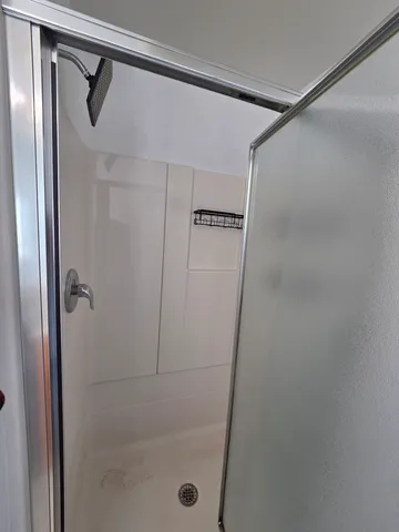 a bathroom with a glass shower door