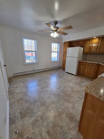 a view of a livingroom with a ceiling fan and window