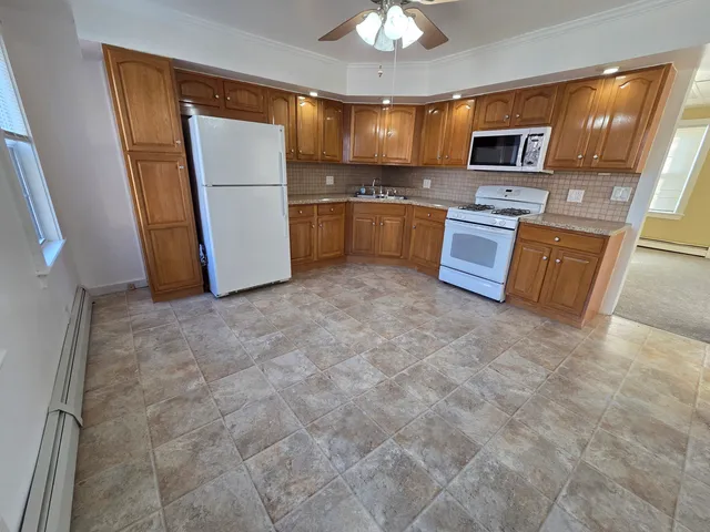 a kitchen with stainless steel appliances granite countertop a refrigerator stove and sink