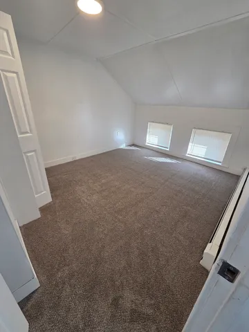 an empty room with windows and entrance