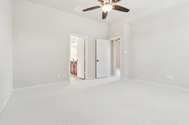 a spacious bathroom with a tub sink and mirror