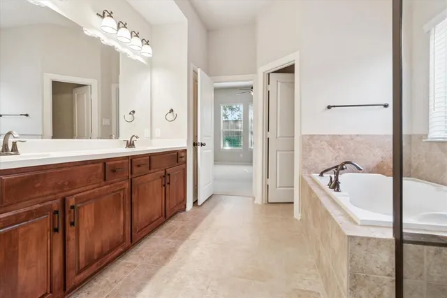 a spacious bathroom with a double vanity sink mirror and
