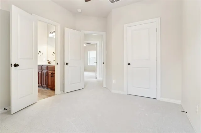 a bedroom with a bed and a potted plant
