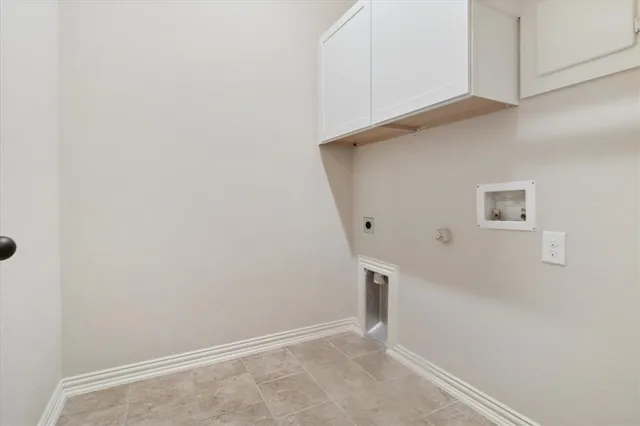 a view of a chair and table in backyard of the house