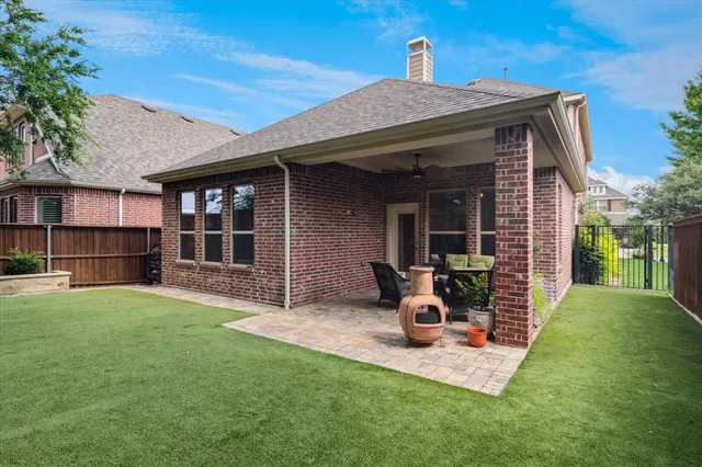 a view of a patio with table and chairs and potted plants