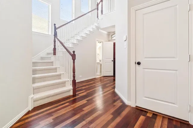 a view of entryway and hall with wooden floor