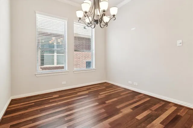 a view of wooden floor and windows in a room
