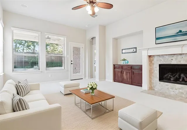 a view of an empty room with a fireplace and a window