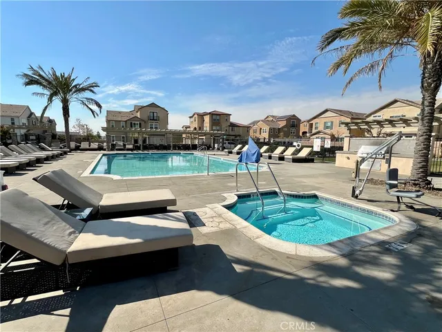 a view of a house with a yard and sitting area