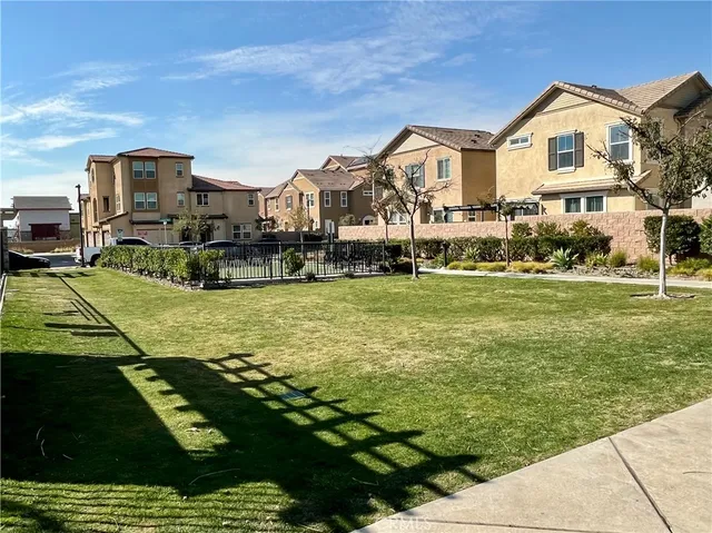 a view of a backyard with a patio and swimming pool