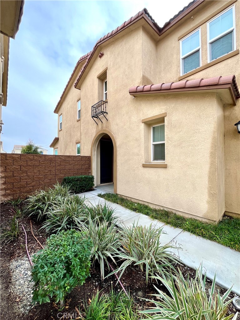 1586 Redwoods Drive Place Upland, CA 91784 - Photo 2 of 18 a front view of a house with garden