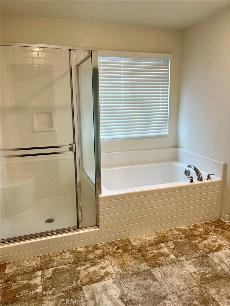 1586 Redwoods Drive Place Upland, CA 91784 - Photo 9 of 18 a bathroom with a bathtub and shower