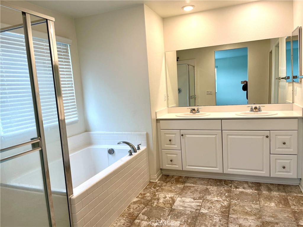 1586 Redwoods Drive Place Upland, CA 91784 - Photo 10 of 18 a bathroom with a sink a bathtub a mirror and vanity