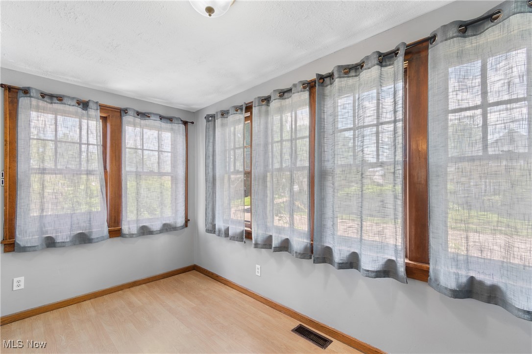 302 Poplar Avenue Northwest Canton, OH 44708 - Photo 10 of 34 Unfurnished sunroom with wood finished floors and baseboards