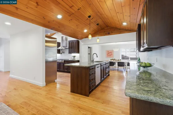 a large kitchen with lots of counter space and stainless steel appliances