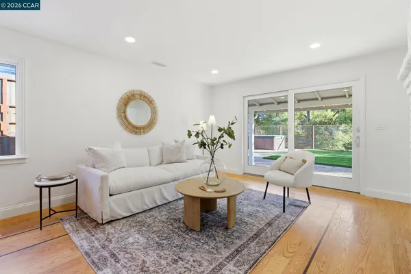a living room with furniture a window and a potted plant
