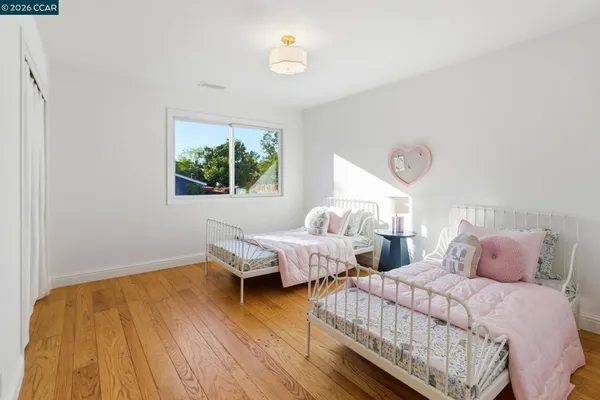 a bedroom with two beds and a window