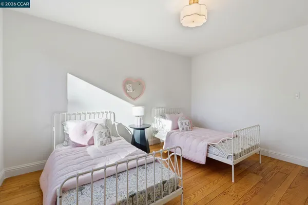 a bedroom with two beds and a table