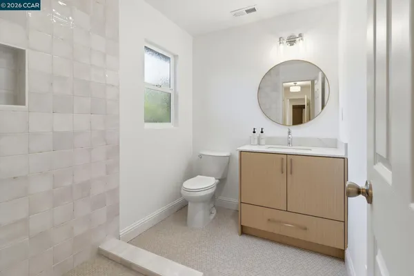 a bathroom with a toilet a sink and a mirror