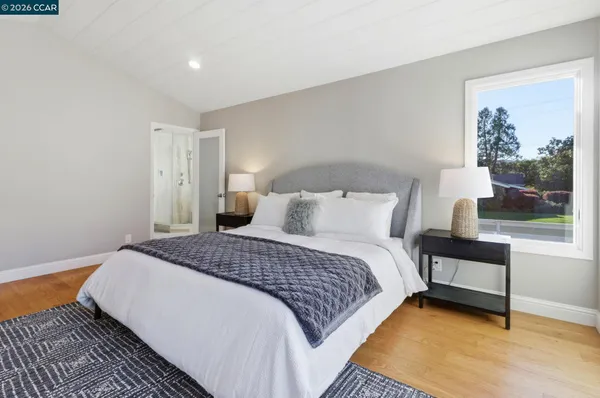 a bedroom with a bed and window