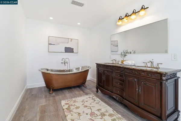 a bathroom with a double vanity sink and a mirror