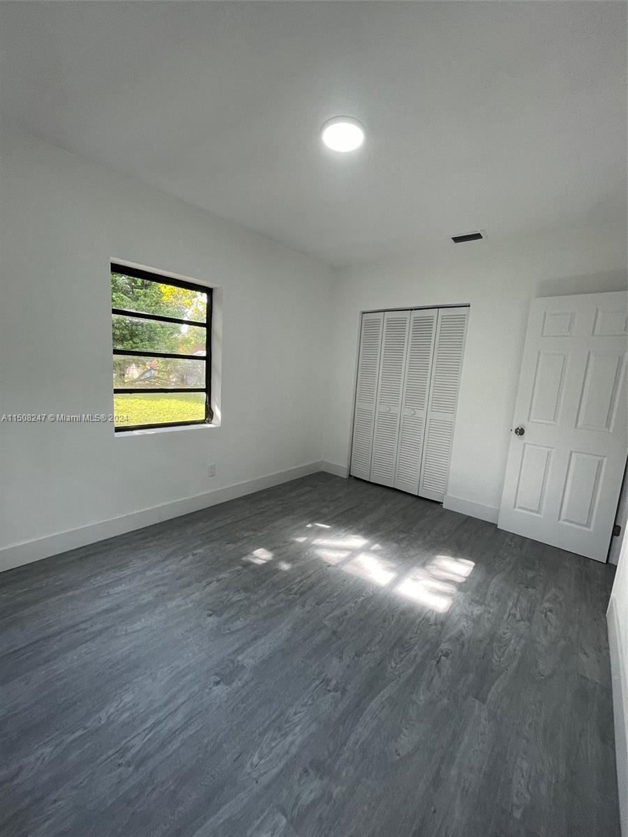 50 East 13th Street Hialeah, FL 33010 - Photo 13 of 17 an empty room with windows and closet