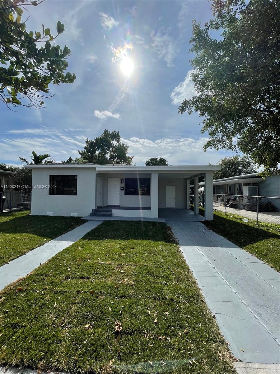 50 East 13th Street Hialeah, FL 33010 - Photo 2 of 17 a front view of a house with garden