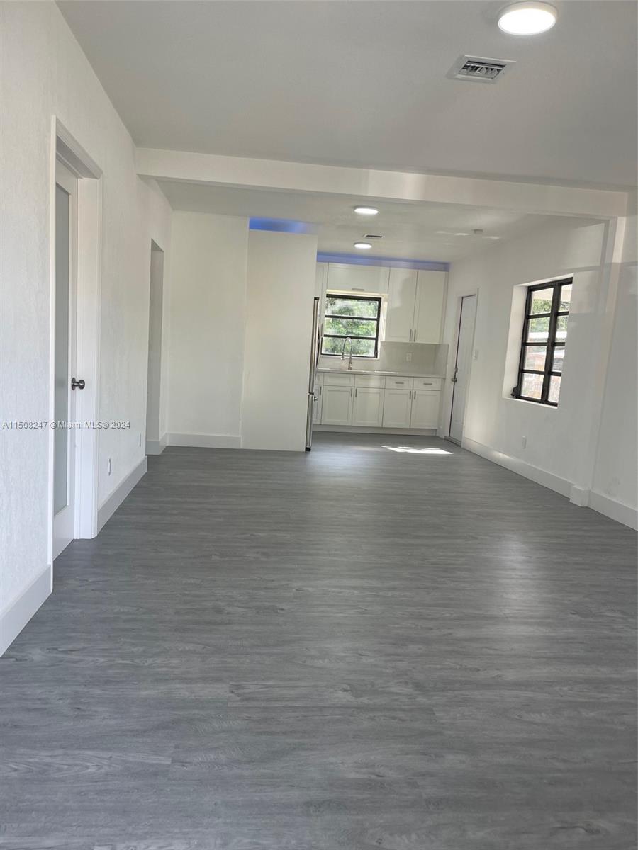 50 East 13th Street Hialeah, FL 33010 - Photo 4 of 17 an empty room with wooden floor and windows