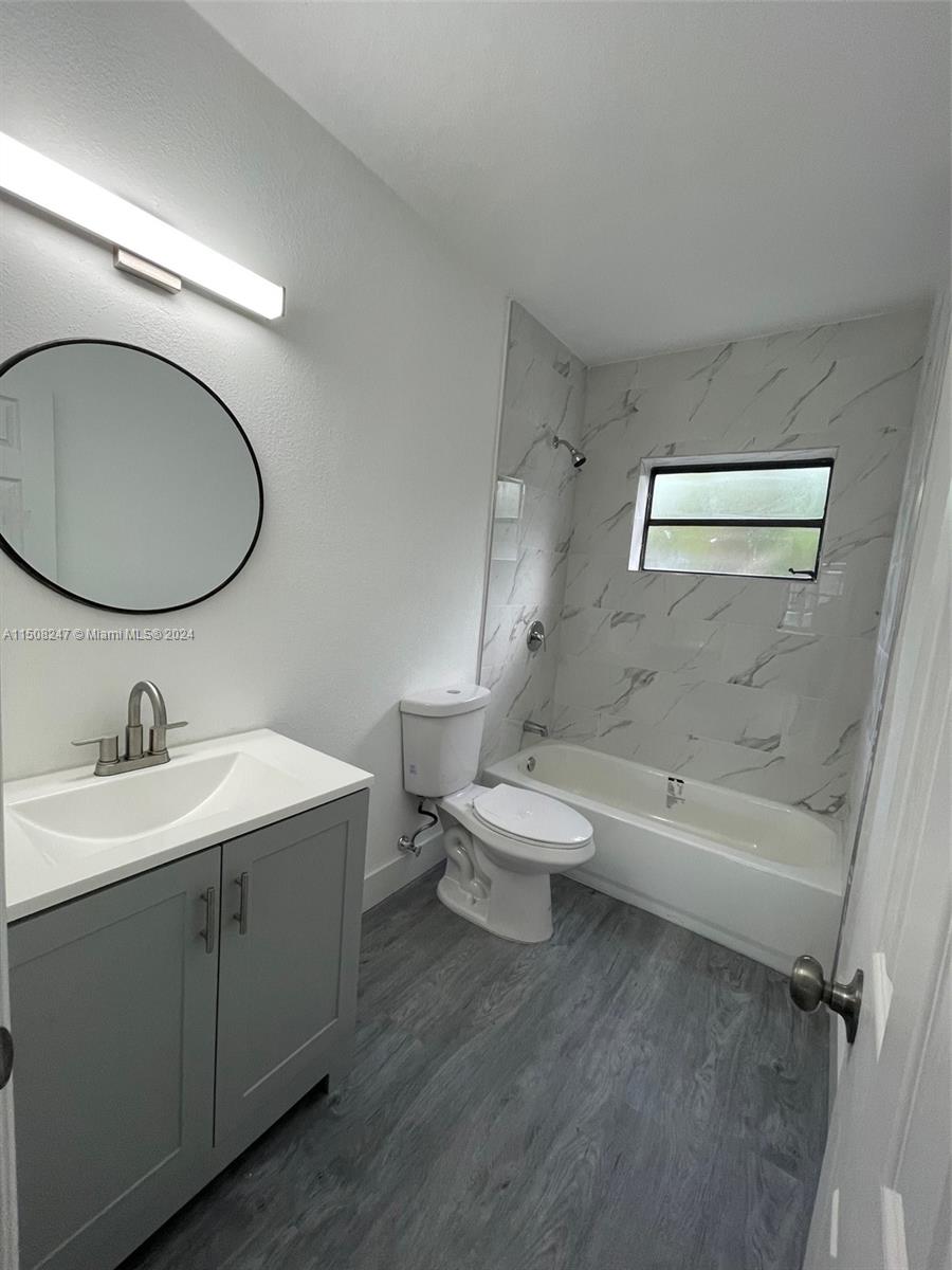 50 East 13th Street Hialeah, FL 33010 - Photo 7 of 17 a bathroom with a toilet a sink and bathtub
