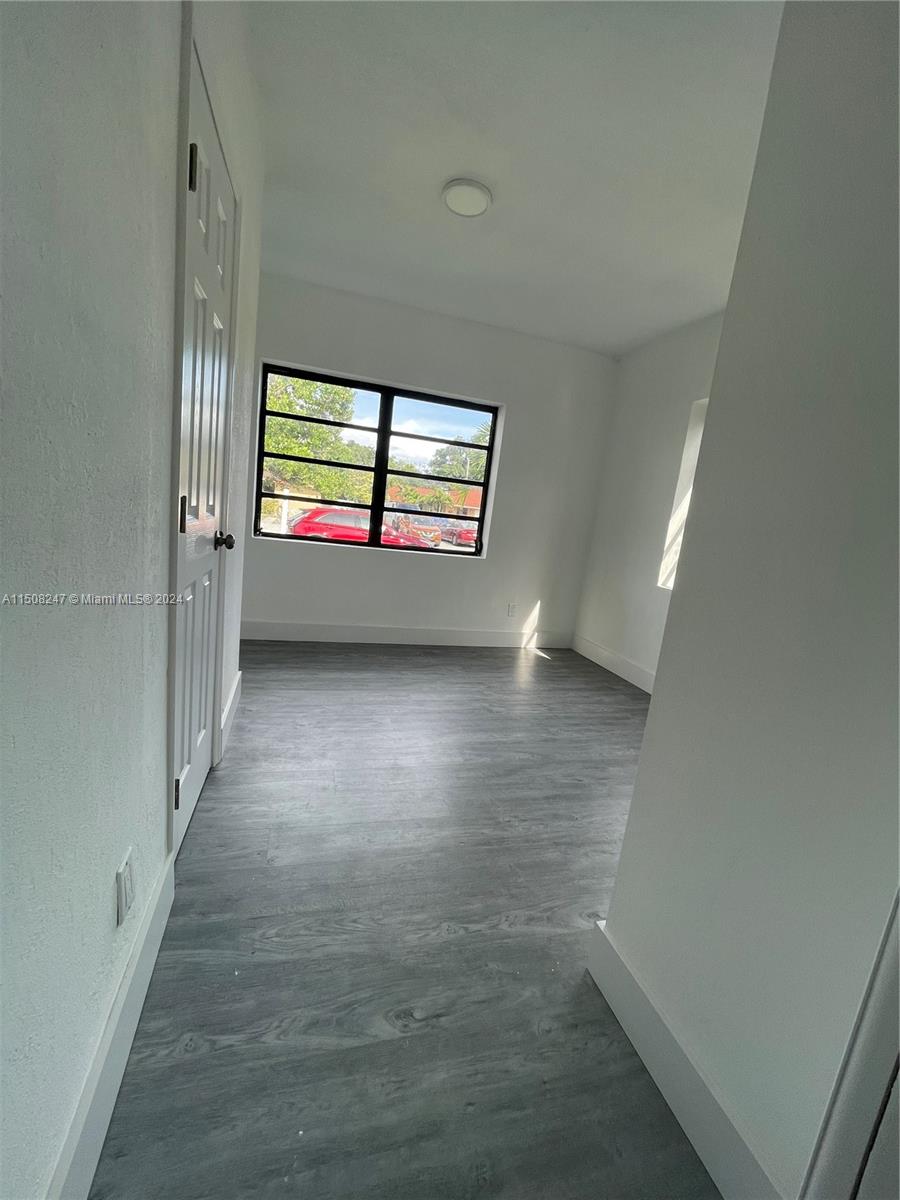 50 East 13th Street Hialeah, FL 33010 - Photo 9 of 17 wooden floor in an empty room with a window