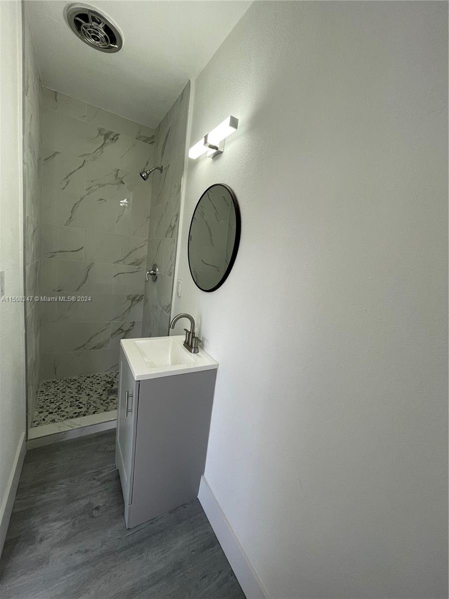 50 East 13th Street Hialeah, FL 33010 - Photo 10 of 17 a bathroom with a sink and a mirror