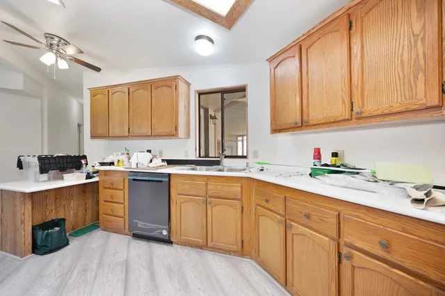 a kitchen with sink cabinets and window