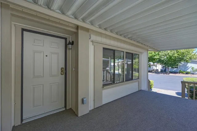 a view of a porch with furniture and garden