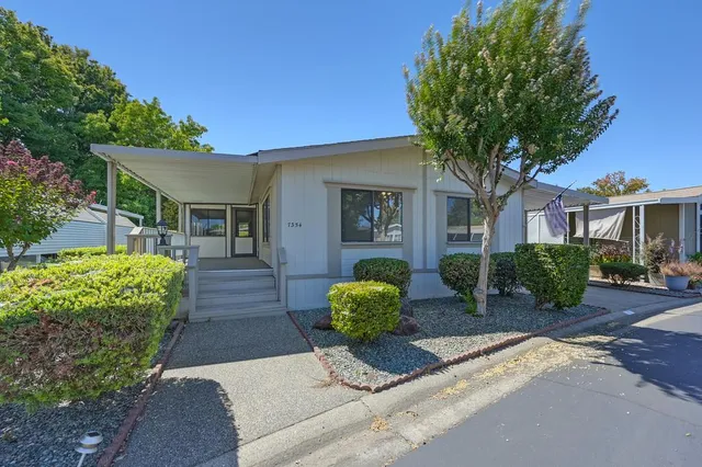 a front view of a house with garden
