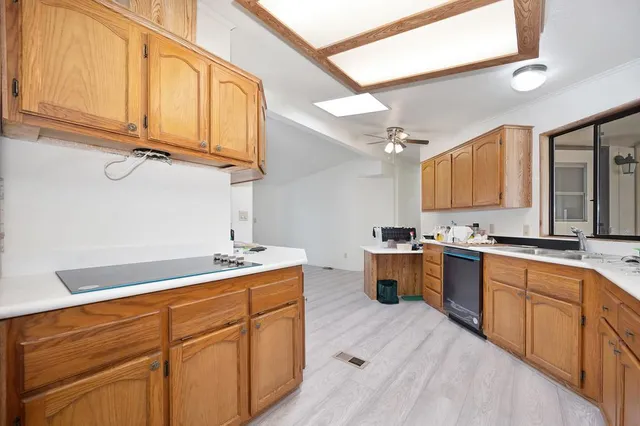 a kitchen with a sink cabinets and window