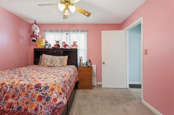 a bed room with a bed and a window