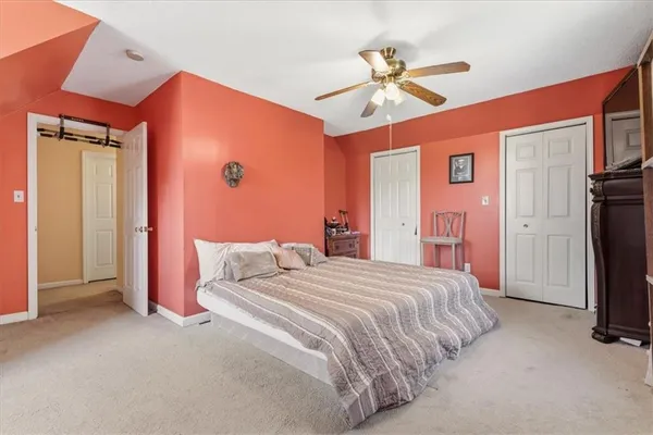 a bedroom with a bed dresser and a window