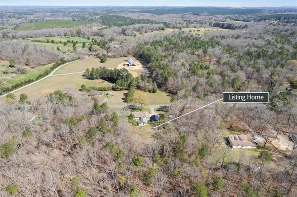an aerial view of a house with a yard