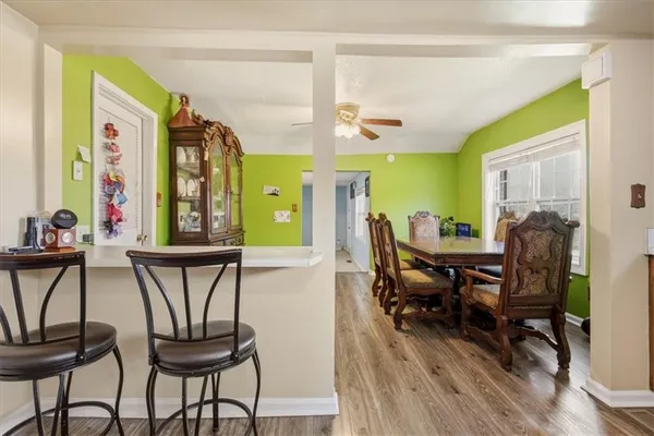 a view of a dining room with furniture and wooden floor