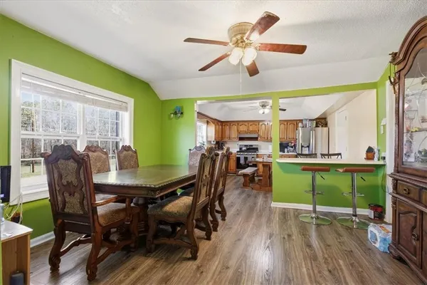 a view of a dining room with furniture and a window