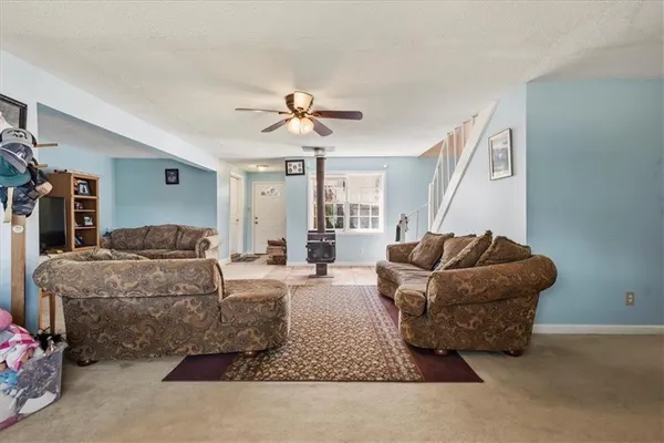 a living room with furniture and a ceiling fan