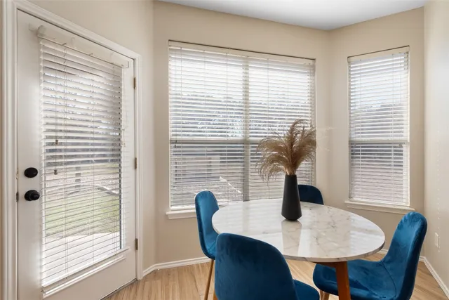 a dining room with furniture and window