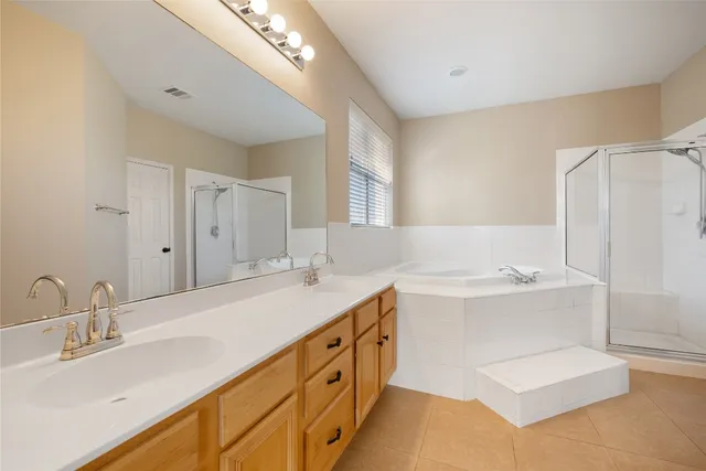 a spacious bathroom with a double vanity sink mirror and double
