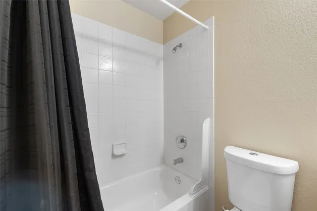 a bathroom with a bathtub and a toilet