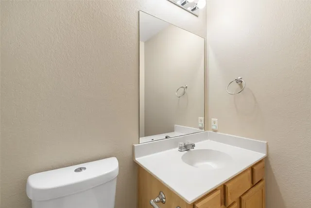 a bathroom with a sink toilet and mirror