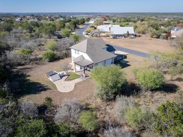 an aerial view of a house with yard
